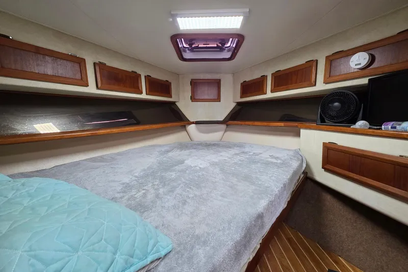 Slide: The Image of Cozy cabin interior of 1990 Topaz 39 Royale yacht with wood accents and bedding. - 16
