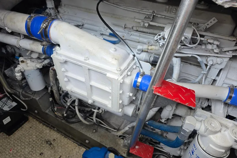 Slide: The Image of Engine compartment of a 1990 Topaz 39 Royale with visible pipes and components. - 18