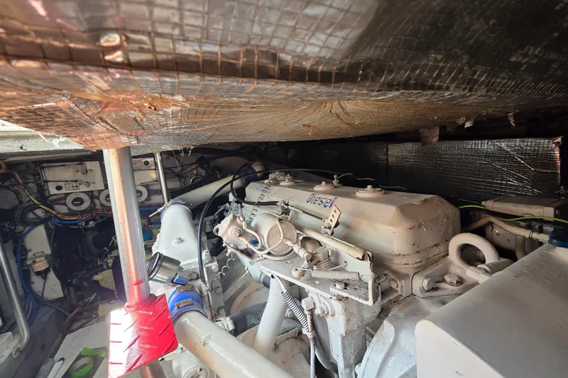 Slide: The Image of Engine room of a 1990 Topaz 39 Royale boat, featuring a diesel engine. - 25
