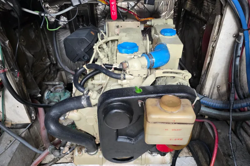 Slide: The Image of Engine compartment of a 1990 Topaz 39 Royale boat, featuring hoses and components. - 26