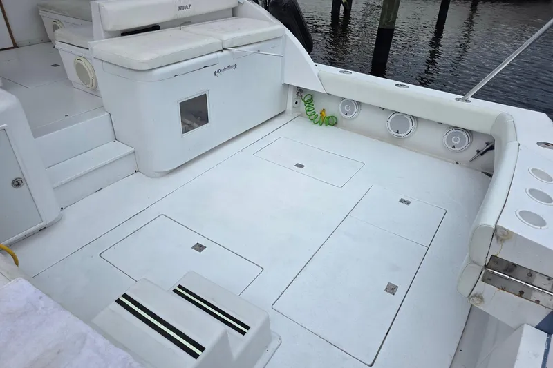 Slide: The Image of Spacious deck of 1990 Topaz 39 Royale boat with seating and storage compartments. - 6