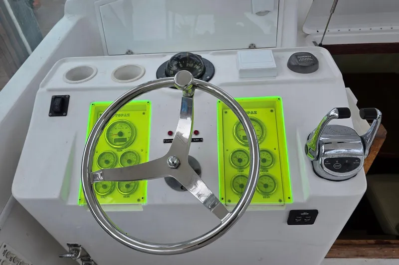 Slide: The Image of Steering console of a 1990 Topaz 39 Royale boat with gauges and controls. - 9