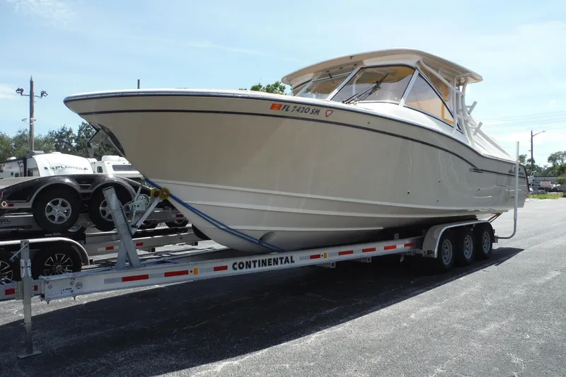 The Image of 2019 Grady-White Freedom 325 boat on trailer, parked outdoors on a sunny day. - 0