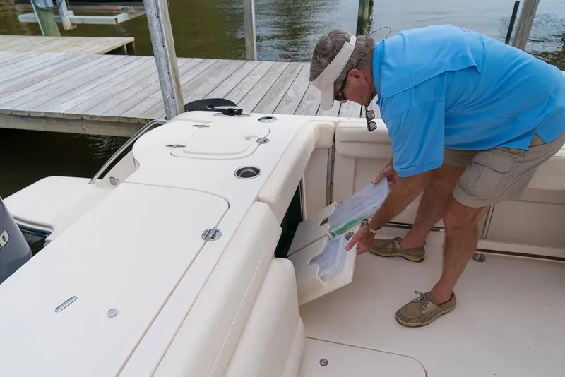 Slide: The Image of Manufacturer Provided Image: Man organizing storage on 2019 Grady-White Freedom 325 boat at dock. - 10