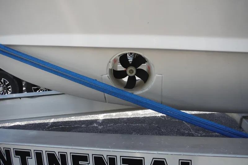 Slide: The Image of 2019 Grady-White Freedom 325 boat with visible propeller and blue strap on trailer. - 13