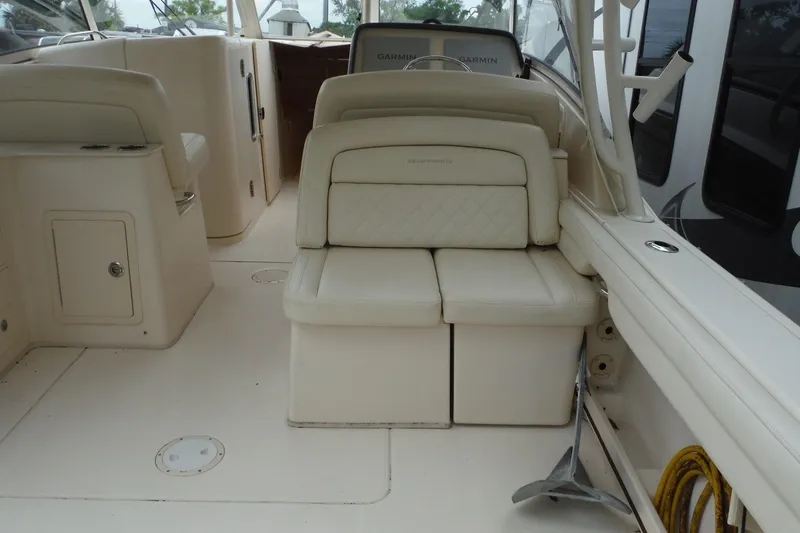 Slide: The Image of 2019 Grady-White Freedom 325 boat interior with cushioned seating and storage compartments. - 18
