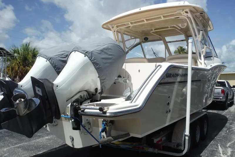 Slide: The Image of 2019 Grady-White Freedom 325 boat on trailer with dual outboard motors. - 2