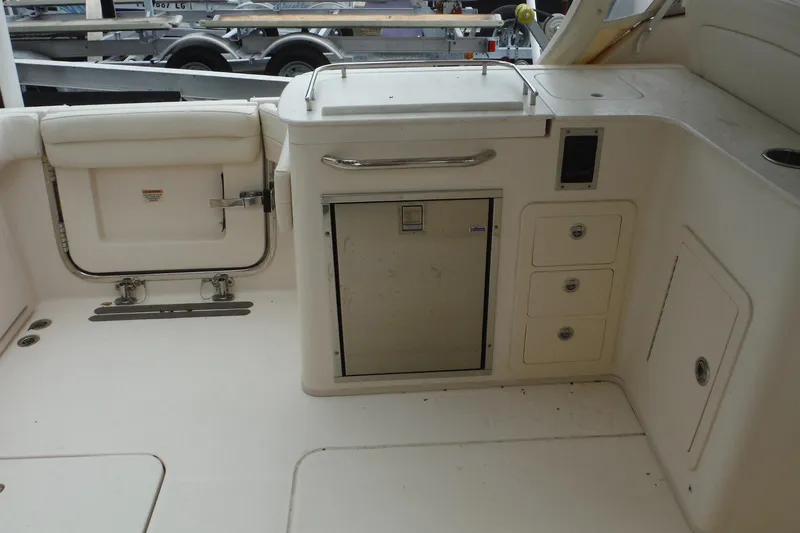 Slide: The Image of 2019 Grady-White Freedom 325 boat interior with storage compartments and seating. - 23