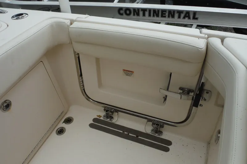 Slide: The Image of 2019 Grady-White Freedom 325 boat interior with white seating and Continental branding. - 25