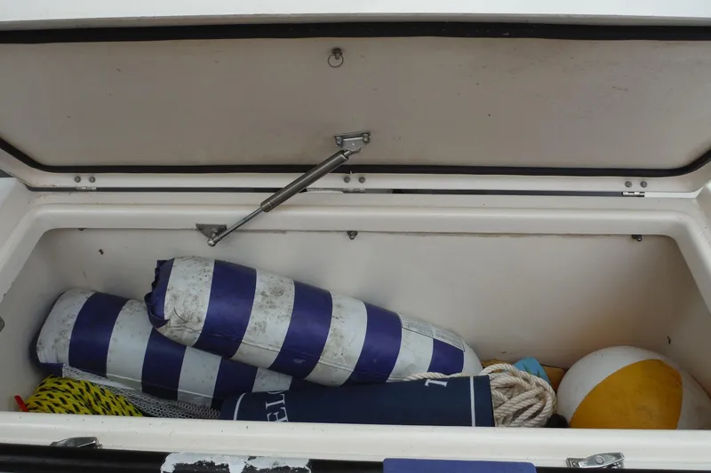 Slide: The Image of Open storage compartment on 2019 Grady-White Freedom 325 boat with nautical gear. - 27