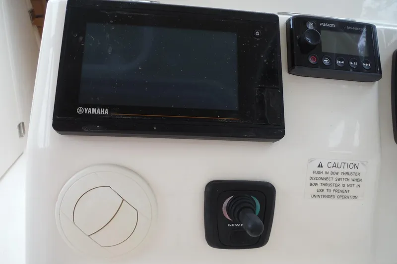 Slide: The Image of Control panel of a 2019 Grady-White Freedom 325 boat with Yamaha display and Fusion audio system. - 31