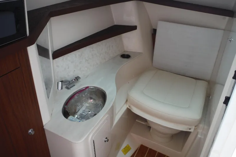 Slide: The Image of 2019 Grady-White Freedom 325 boat interior with sink and toilet. - 32