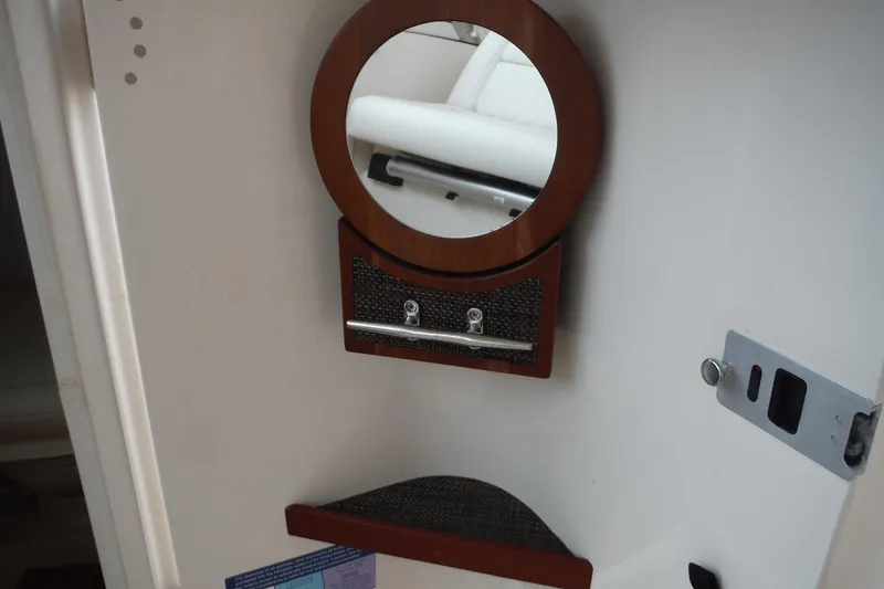 Slide: The Image of Interior of 2019 Grady-White Freedom 325 boat with round mirror and storage shelf. - 34
