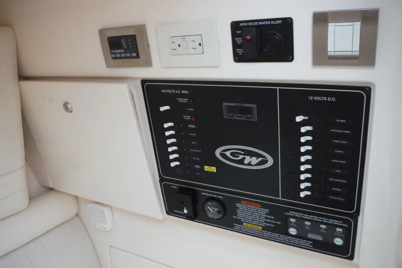 Slide: The Image of Control panel of a 2019 Grady-White Freedom 325 boat, featuring electrical switches and alerts. - 38