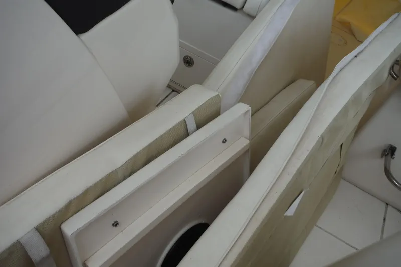 Slide: The Image of Interior seating of 2019 Grady-White Freedom 325 boat, featuring white cushions and storage. - 40