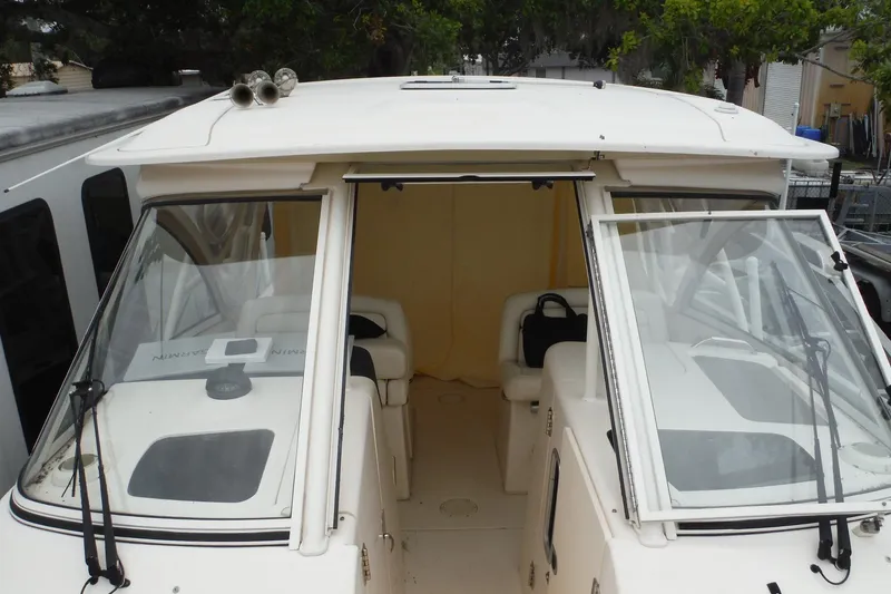 Slide: The Image of 2019 Grady-White Freedom 325 boat interior with open windshield and seating area. - 46