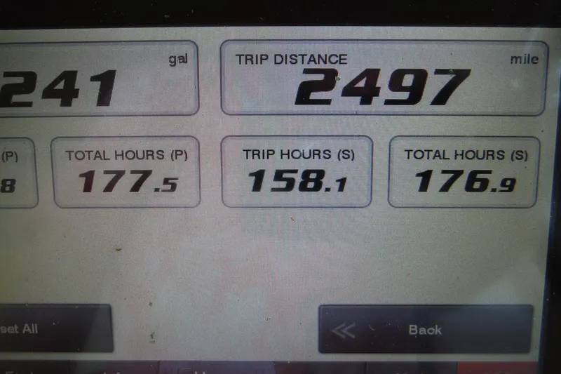 Slide: The Image of Dashboard display of a 2019 Grady-White Freedom 325 showing trip distance and engine hours. - 48