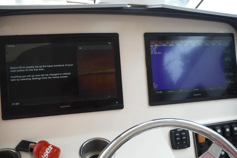 Slide: The Image of Dashboard of a 2019 Grady-White Freedom 325 boat with Garmin displays. - 49