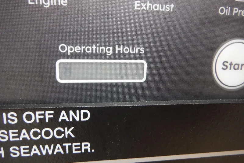 Slide: The Image of Close-up of Grady-White Freedom 325 control panel, showing operating hours display. - 51