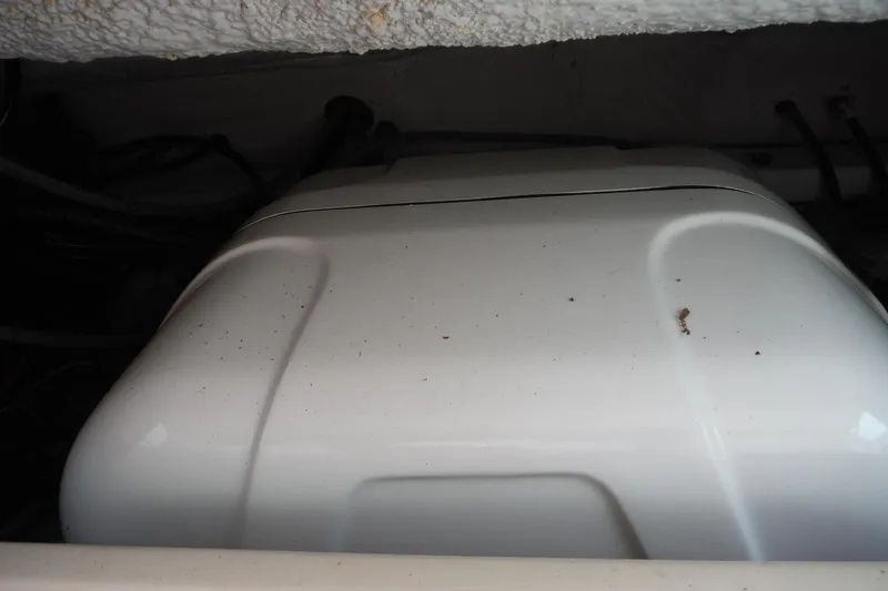 Slide: The Image of Engine compartment of a 2019 Grady-White Freedom 325 boat, showing a white engine cover. - 52