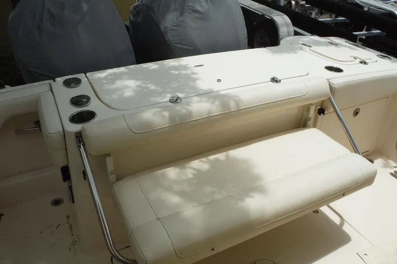 Slide: The Image of 2019 Grady-White Freedom 325 boat interior with foldable seating and cup holders. - 54