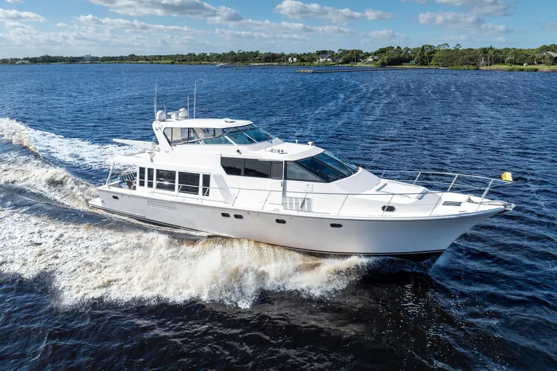 The Image of 2009 Pacific Mariner 65 Motoryacht cruising on open water under a clear sky. - 0