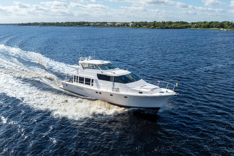 Slide: The Image of 2009 Pacific Mariner 65 Motoryacht cruising on open water under a clear sky. - 3