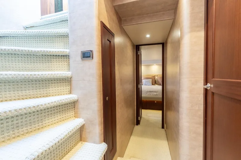 Slide: The Image of Interior hallway of 2009 Pacific Mariner 65 Motoryacht with carpeted stairs and cozy bedroom. - 48