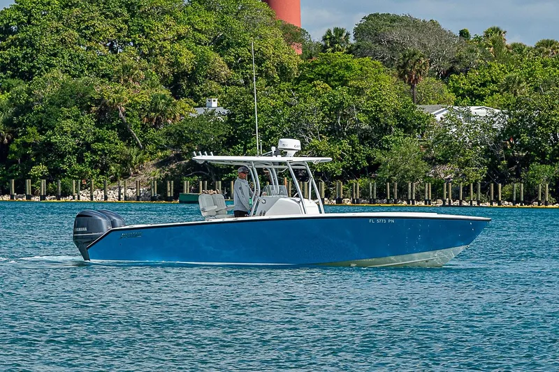 Slide: The Image of 2007 Jupiter 29 FS boat cruising on a scenic waterway with lush greenery. - 1
