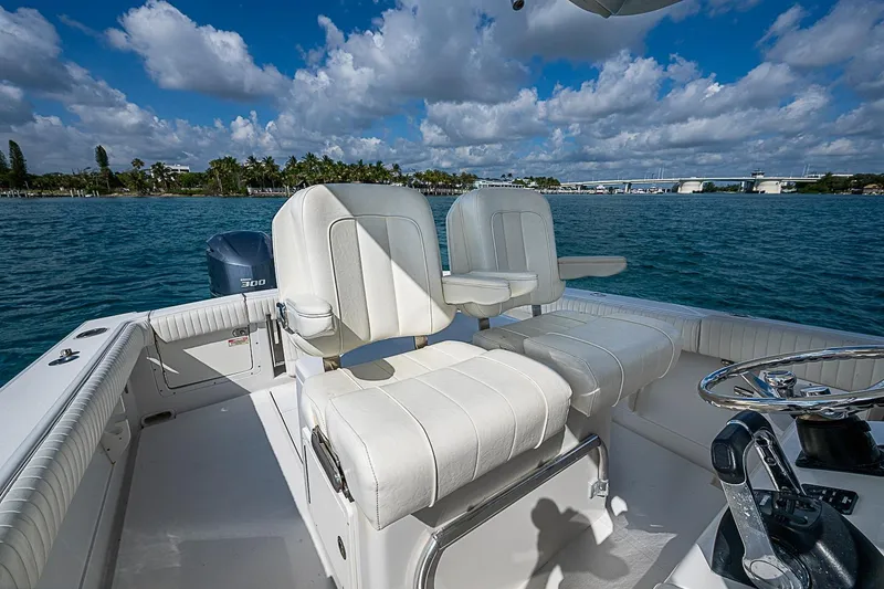 Slide: The Image of 2007 Jupiter 29 FS boat interior with white seating, steering wheel, and ocean view. - 10