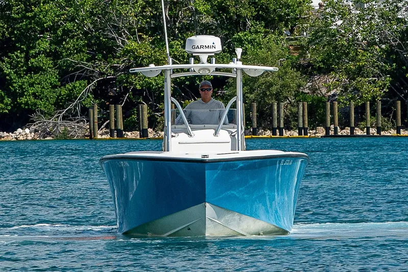 Slide: The Image of 2007 Jupiter 29 FS boat cruising on water with lush greenery in the background. - 22