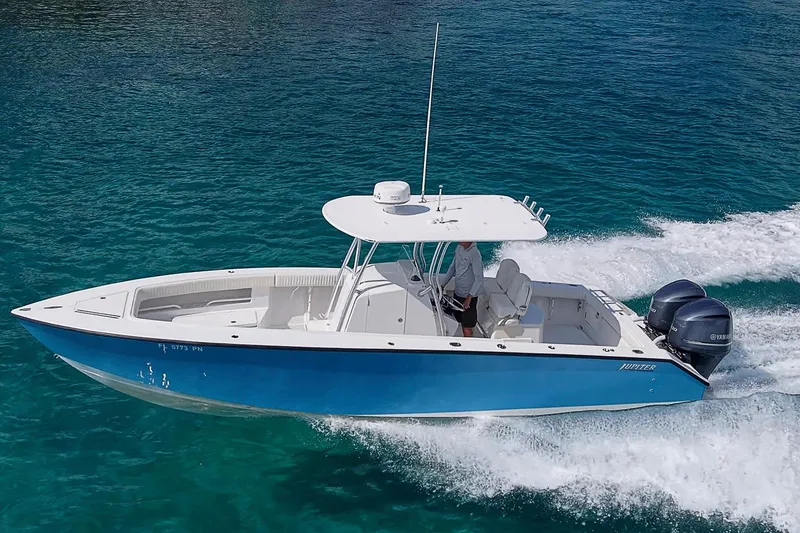 Slide: The Image of 2007 Jupiter 29 FS boat on calm water under a clear blue sky. - 23