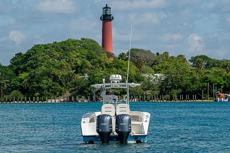 Slide: The Image of 2007 Jupiter 29 FS boat on water near lighthouse and lush greenery. - 3