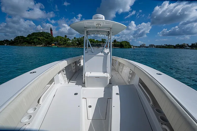 Slide: The Image of 2007 Jupiter 29 FS boat on water, clear sky, lush island background. - 7