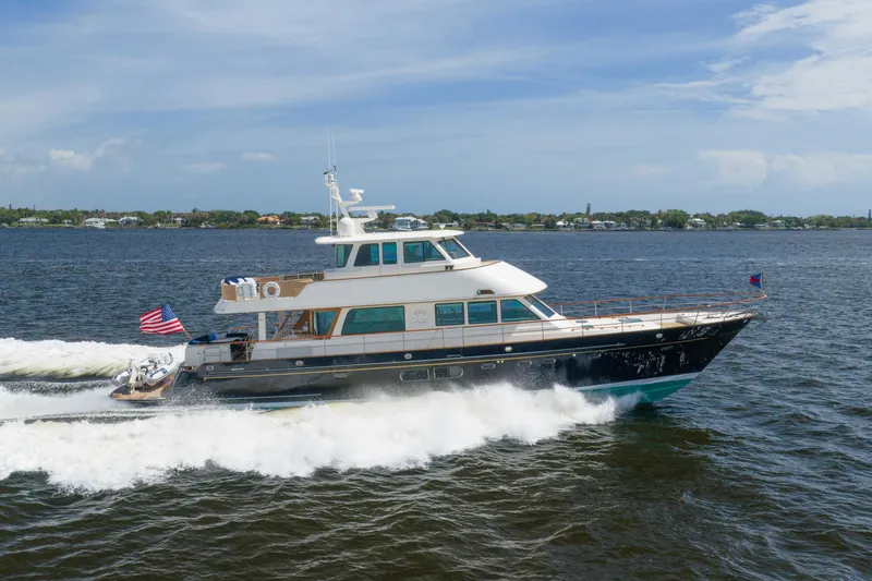 The Image of 2022 Hunt Yachts Ocean 76EP cruising on open water under a clear sky. - 0