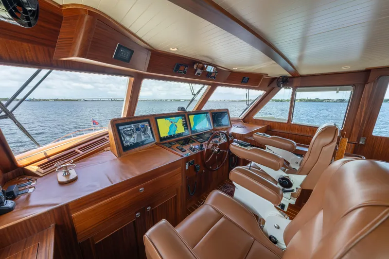 Slide: The Image of Luxurious helm of 2022 Hunt Ocean 76EP yacht with leather seats and navigation screens. - 10
