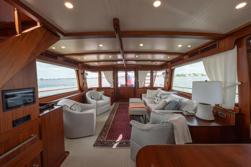 Slide: The Image of Luxurious interior of 2022 Hunt Ocean 76EP yacht with elegant seating and panoramic windows. - 16