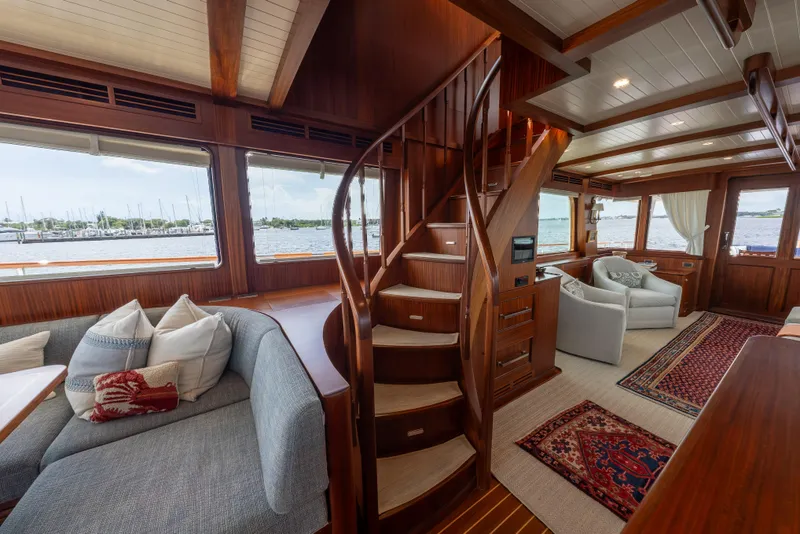 Slide: The Image of Luxurious interior of 2022 Hunt Ocean 76EP yacht with elegant wood finishes and spiral staircase. - 18