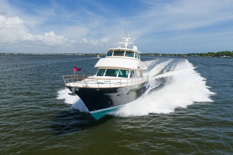 Slide: The Image of Luxury 2022 Hunt Ocean 76EP yacht cruising on open water under clear skies. - 2