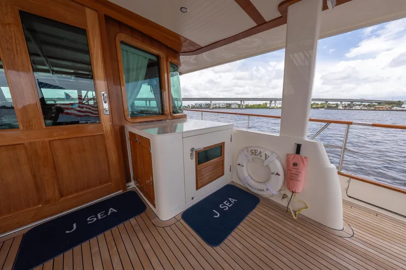 Slide: The Image of Luxury deck of 2022 Hunt Ocean 76EP yacht with wooden finishes and ocean view. - 21