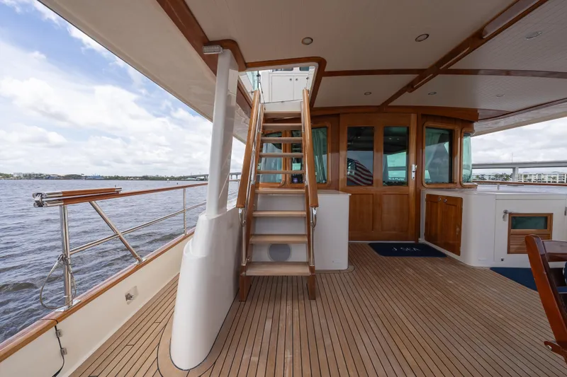 Slide: The Image of Luxurious 2022 Hunt Ocean 76EP yacht deck with wooden stairs and scenic water view. - 22