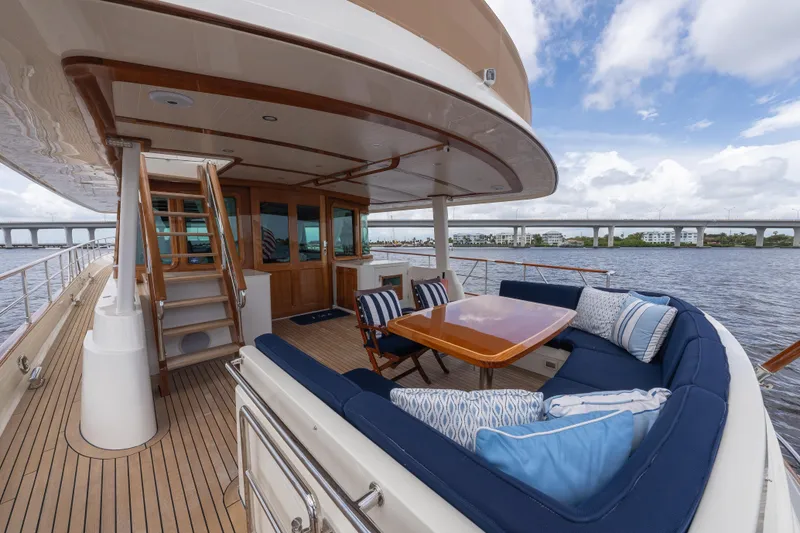 Slide: The Image of Luxurious 2022 Hunt Ocean 76EP yacht deck with elegant seating and scenic water view. - 23