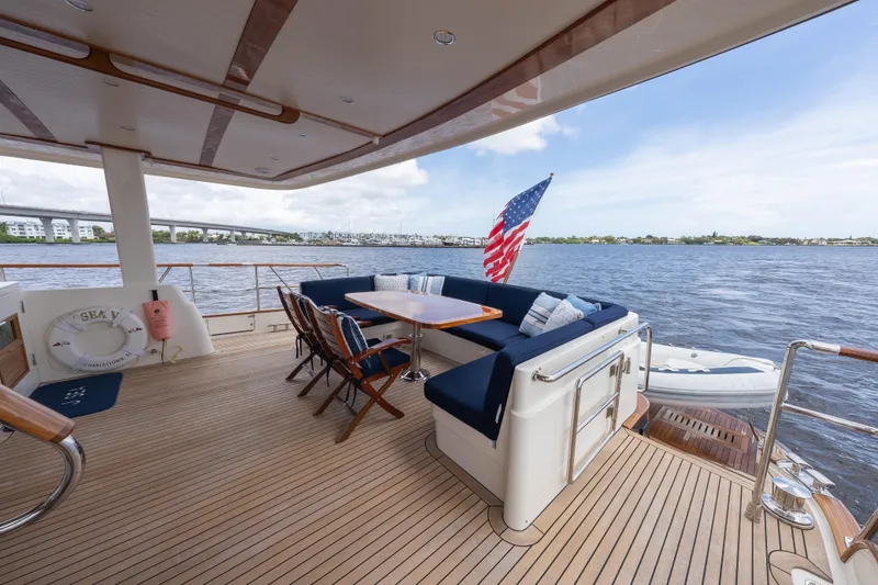 Slide: The Image of Luxury deck of 2022 Hunt Ocean 76EP yacht with seating and American flag. - 24