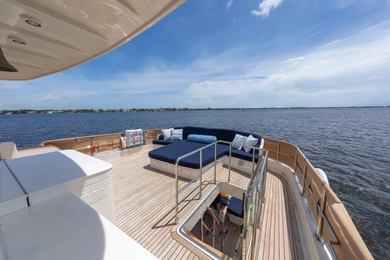 Slide: The Image of Luxurious deck of 2022 Hunt Ocean 76EP yacht with seating, overlooking serene waters. - 25