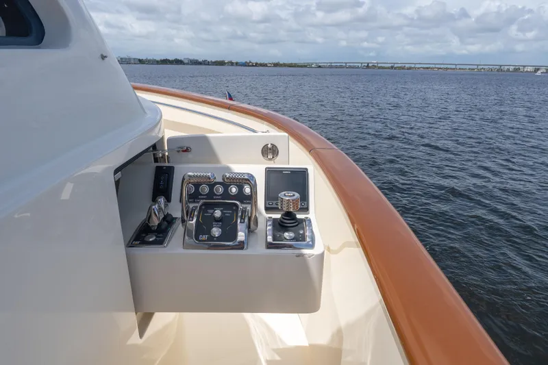 Slide: The Image of Control panel on 2022 Hunt Yachts Ocean 76EP, overlooking calm waters. - 27