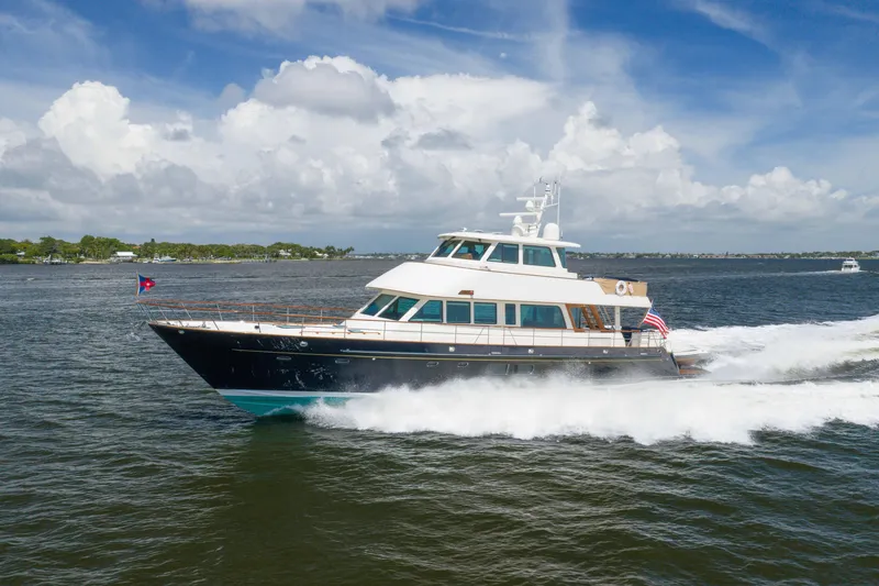 Slide: The Image of 2022 Hunt Yachts Hunt Ocean 76EP cruising on open water under a blue sky. - 3