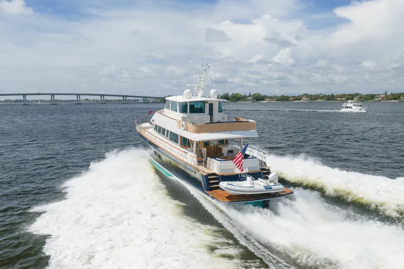 Slide: The Image of Luxury 2022 Hunt Ocean 76EP yacht cruising on open water. - 4