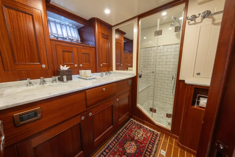 Slide: The Image of Luxurious bathroom in 2022 Hunt Ocean 76EP yacht with wood cabinetry and glass shower. - 43