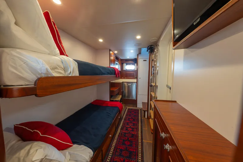 Slide: The Image of Interior of 2022 Hunt Ocean 76EP yacht with bunk beds and elegant wood finish. - 51