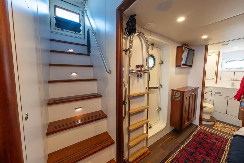 Slide: The Image of Interior of 2022 Hunt Ocean 76EP yacht featuring stairs, ladder, and bathroom. - 53